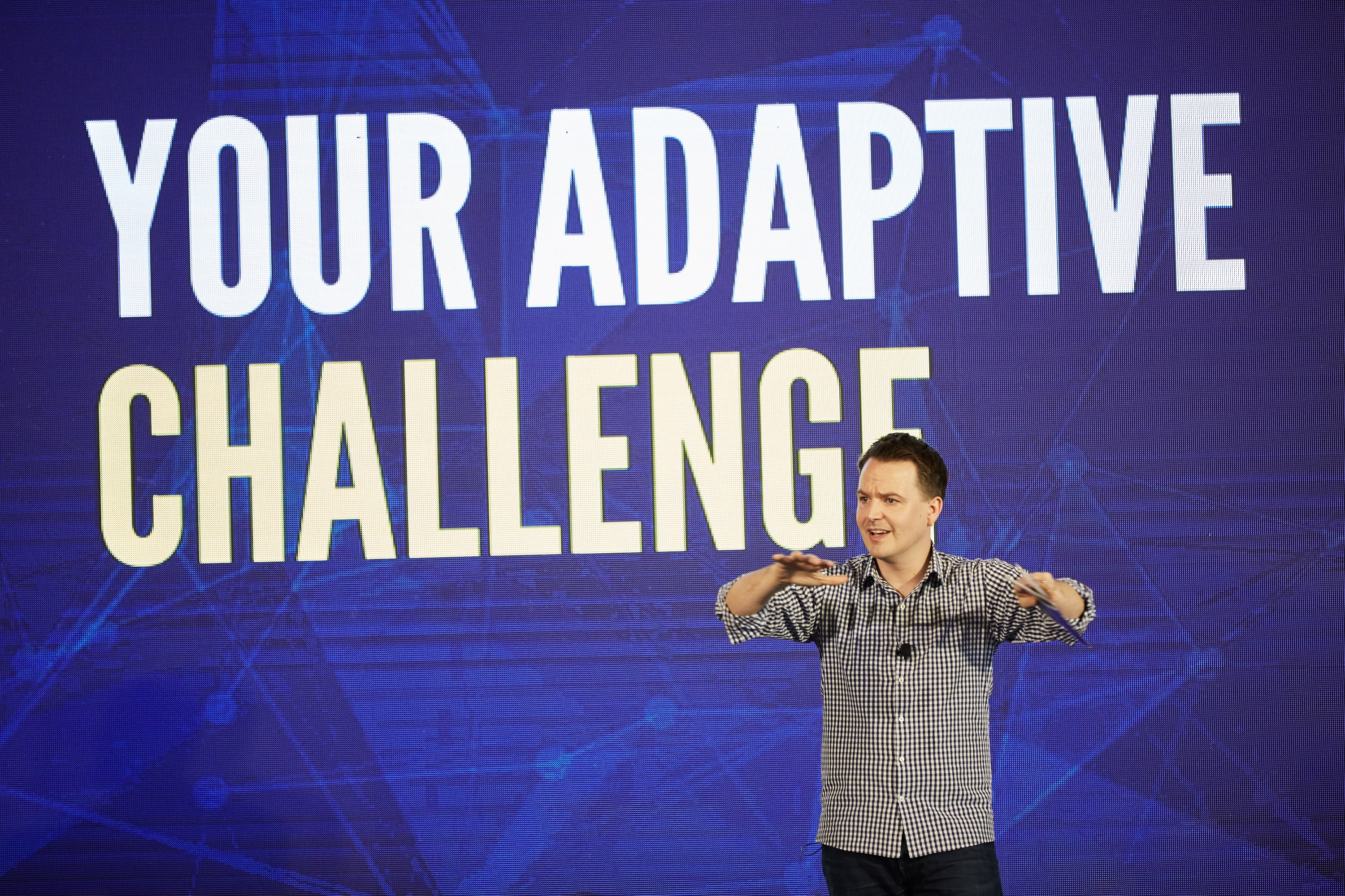 Shaun Kenny presenting Your Adaptive Challenge on stage