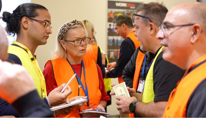 A team huddled in discussion during Built to Win