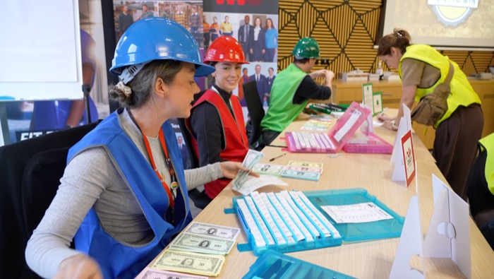 A participant reviewing cards at a Built to Win table