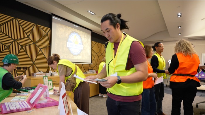 A participant reading materials during Built to Win