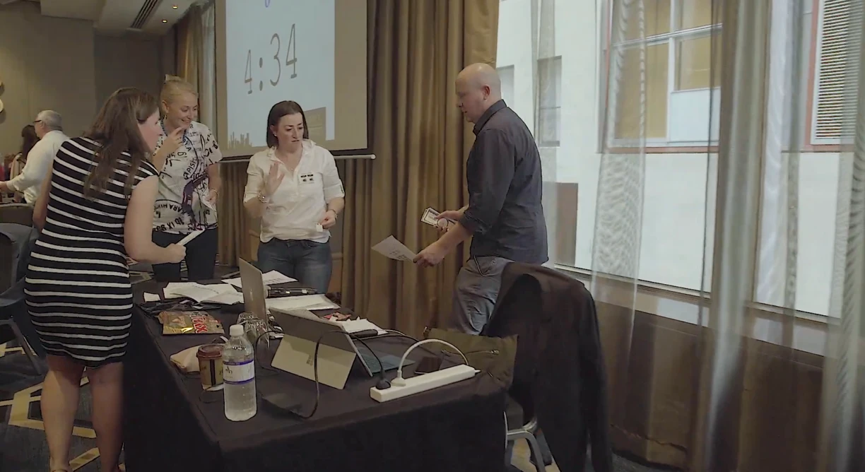 Traders racing between tables with the period clock counting down on screen