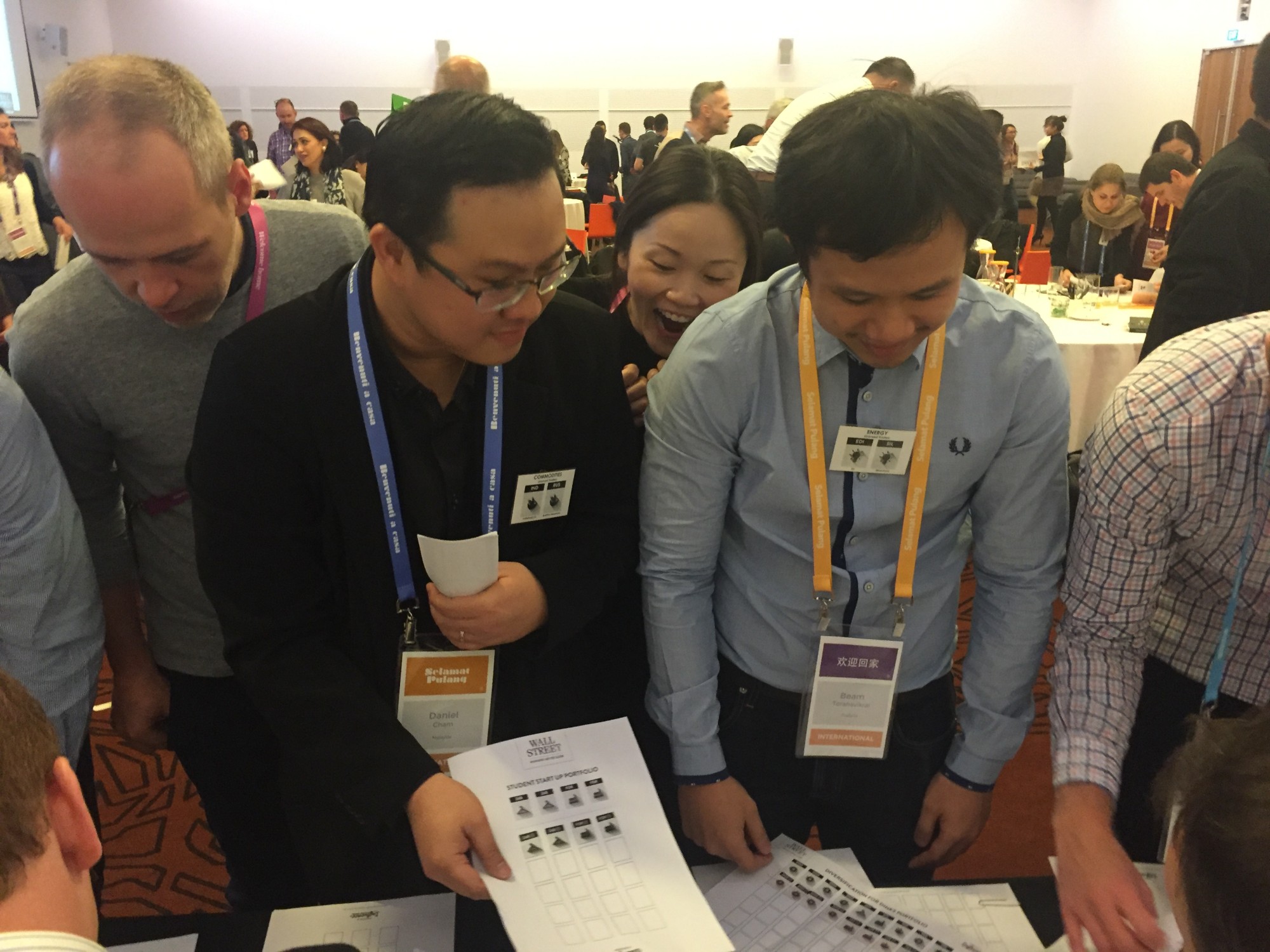 Conference delegates huddled over their trading sheet in a full ballroom
