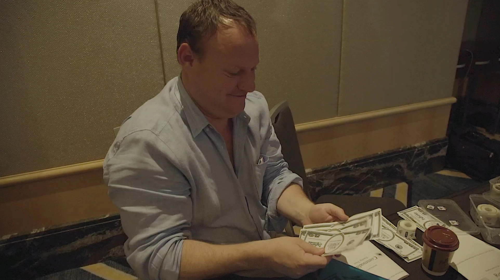 A participant counting Wall Street dollars at the end of a trading period