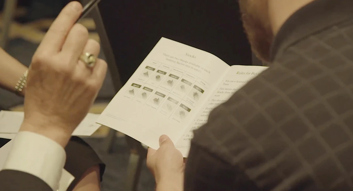 A participant reading the Wall Street rules booklet